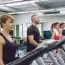 People Training Over Treadmills On Fitness Center