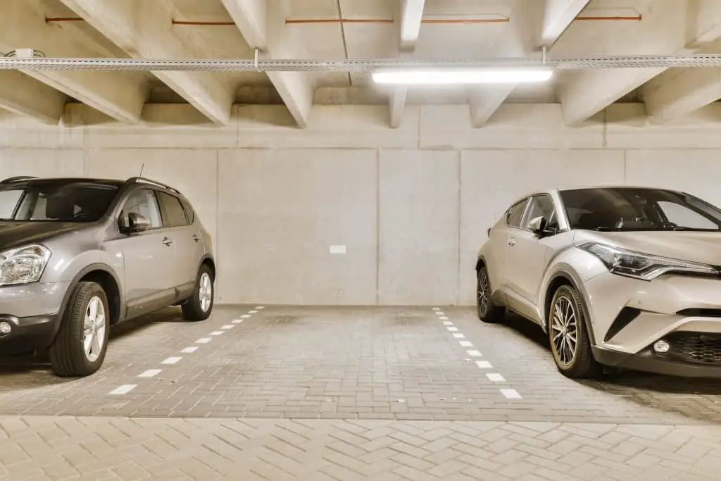 Two Cars Parked In A Parking Garage