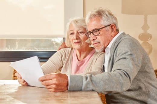 Senior Couple Reading Together A Retirement Plan