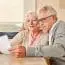 Senior Couple Reading Together A Retirement Plan