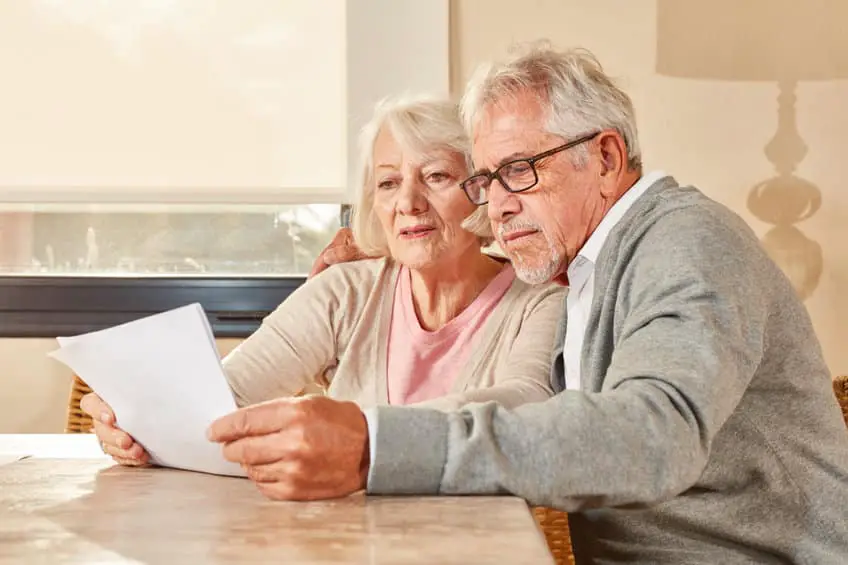 Senior Couple Reading Together A Retirement Plan