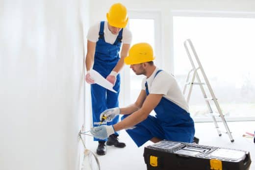 Builders With Tablet Pc And Equipment Indoors