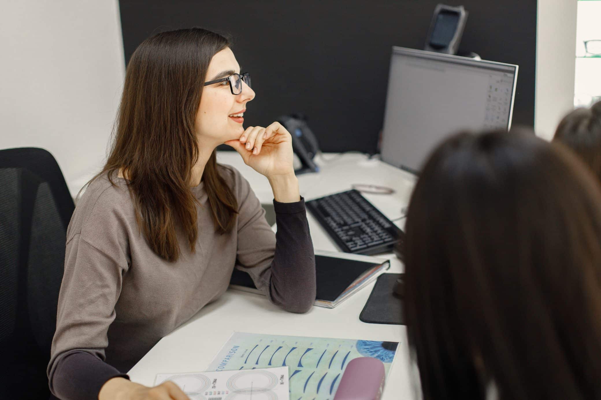 Professional Female Optician Sitting At The Table And Working