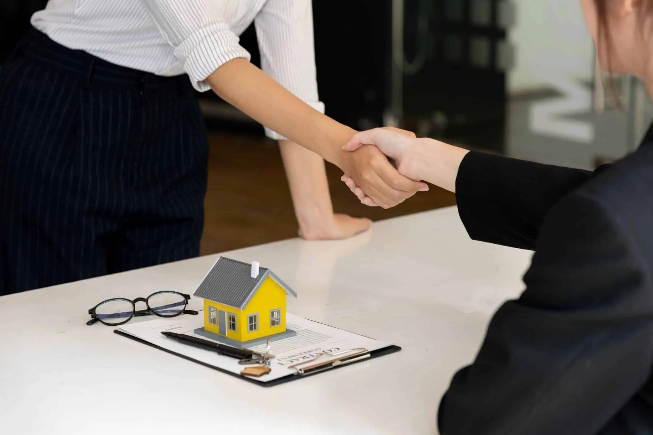 Real Estate Broker And Customer Shaking Hands After Signing A Contract: Real Estate, Home Loan And Insurance Concept