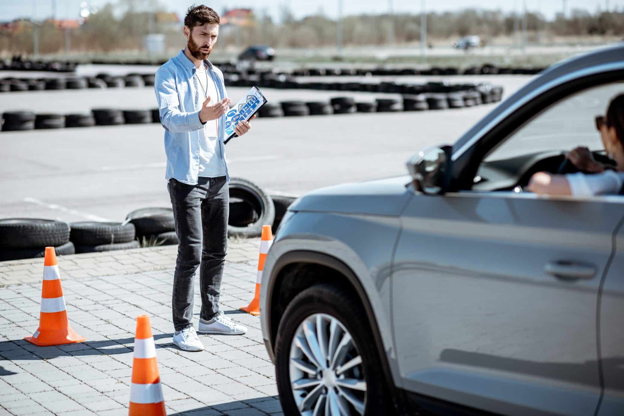 Instructor Teaching To Drive A Car On The Training Ground