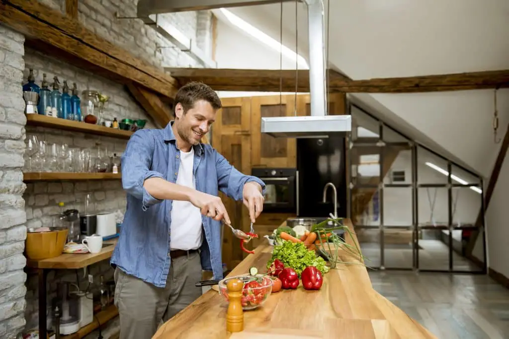 Young Man Preparing Food In The Kitchen