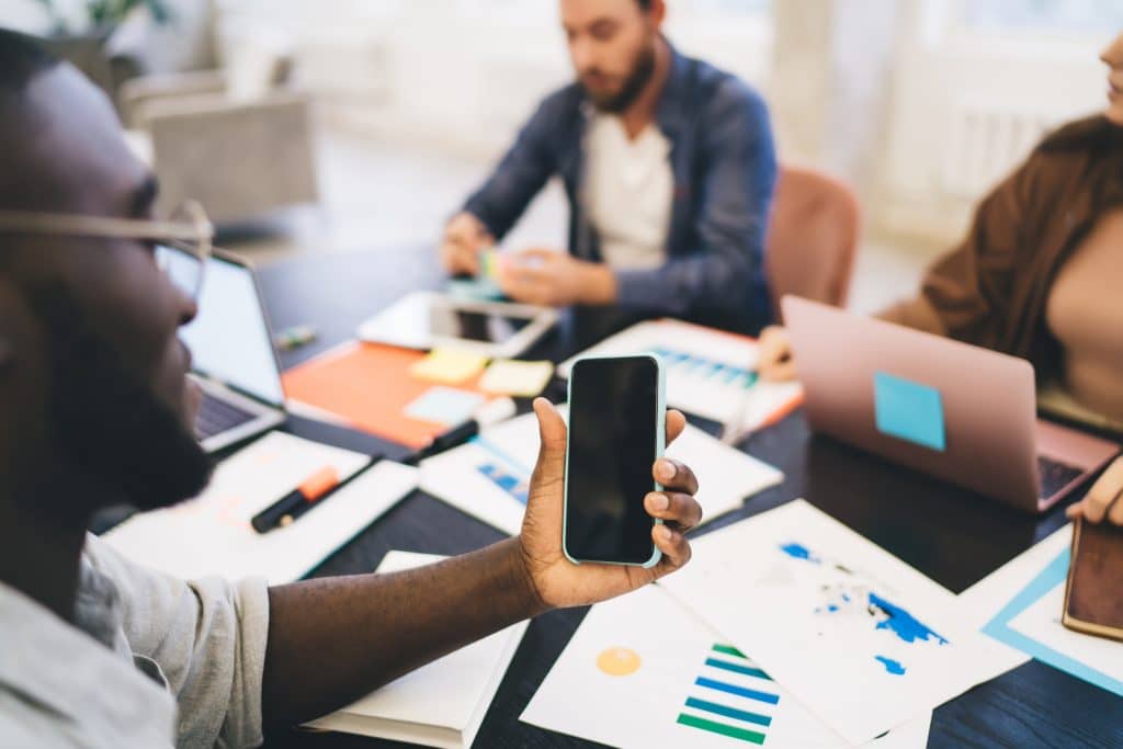 Crop Guy With Mockup Phone Working In Advertising Company