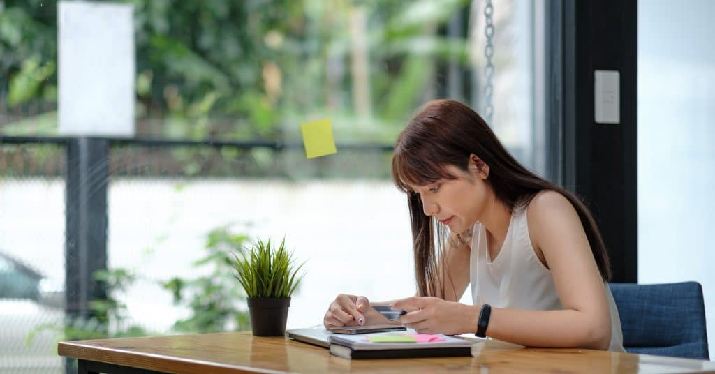 Young Asian Girl Using Smartphone Buying Online Shopping By Credit Card At Home. Lifestyle Woman At House Concept