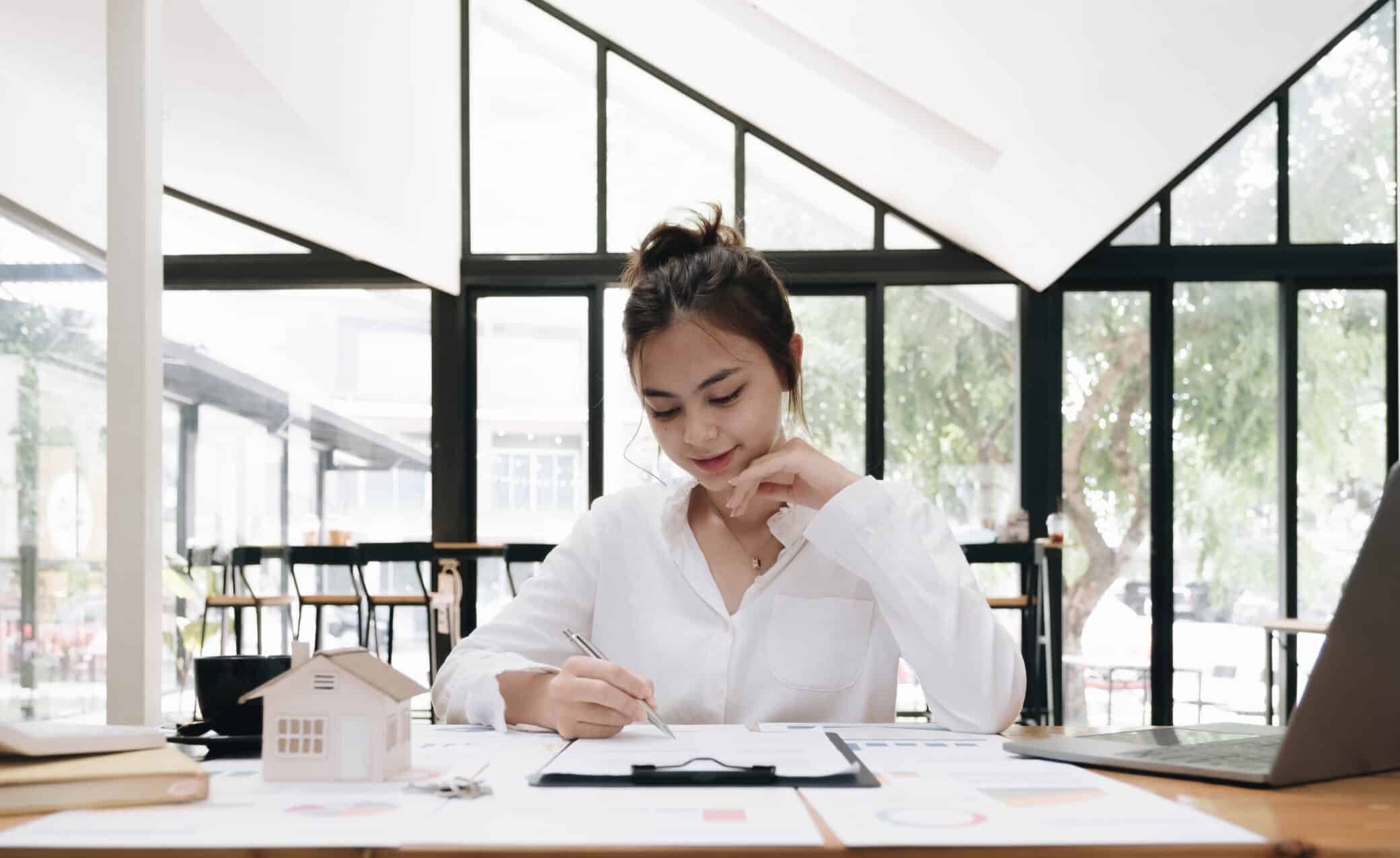 Real Estate Agent And Customer Signing Contract To Buy House, Insurance Or Loan Real Estate. Rent A House, Get Insurance, Or Mortgage Loan Real Estate Or Property.