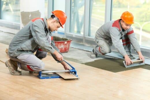 15973849 Two Tilers At Industrial Floor Tiling Renovation