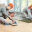 15973849 Two Tilers At Industrial Floor Tiling Renovation