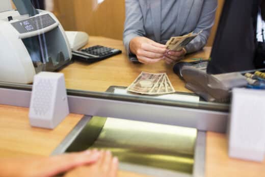 Clerk Counting Cash Money At Bank Office