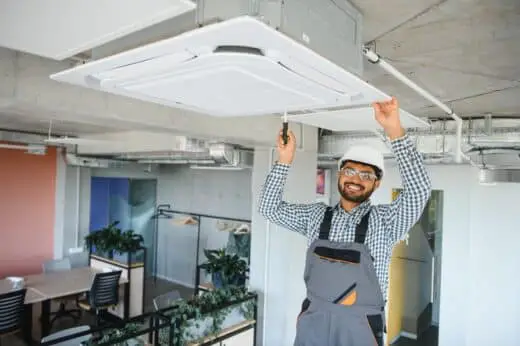 Professional Technician Maintaining Modern Air Conditioner Indoors. Space For Text