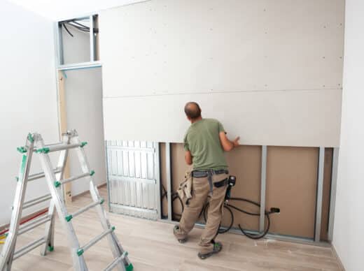 Worker Building Plasterboard Wall.