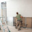 Worker Building Plasterboard Wall.