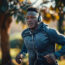 A Dedicated Sportsman Of African Descent Finds His Rhythm While Running Outdoors, His Headphones Piping Motivating Music Into His Ears.