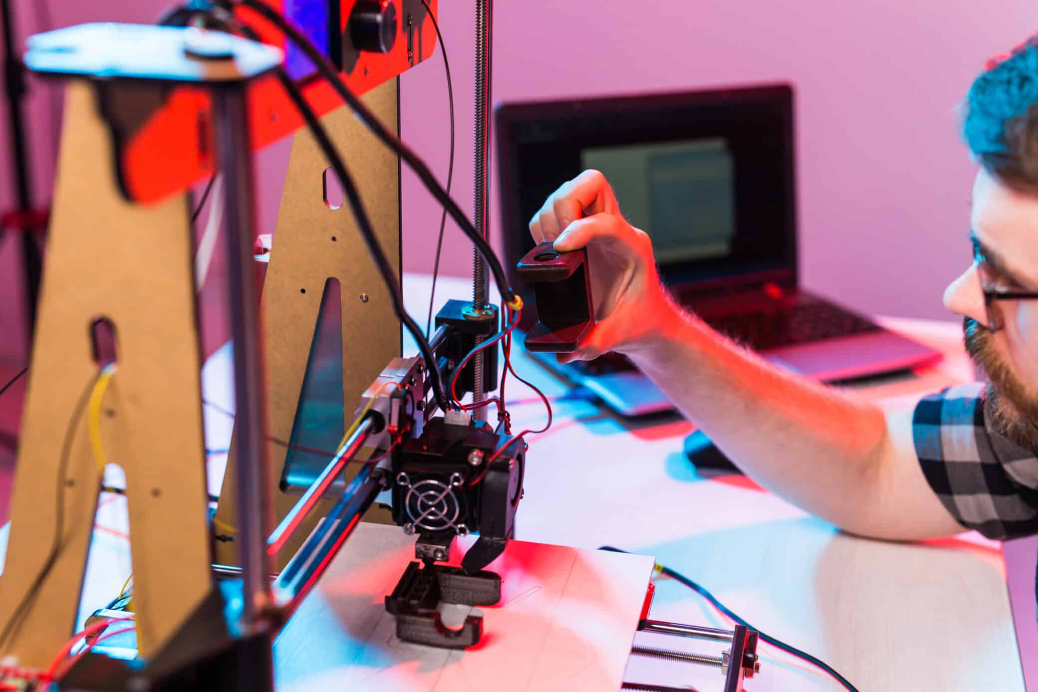 Man Student Makes The Item On The 3d Printer