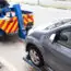 Tow Truck Towing A Broken Down Car On The Street